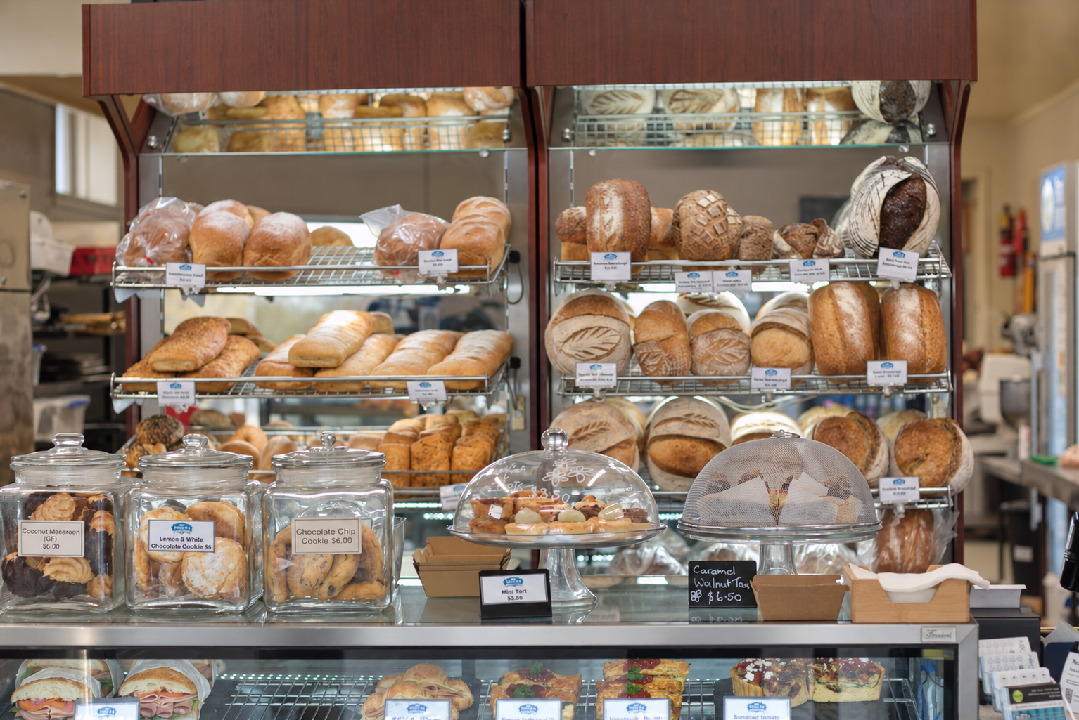 Pantry d’Or bread cabinet filled with fresh artisan loaves and baked goods